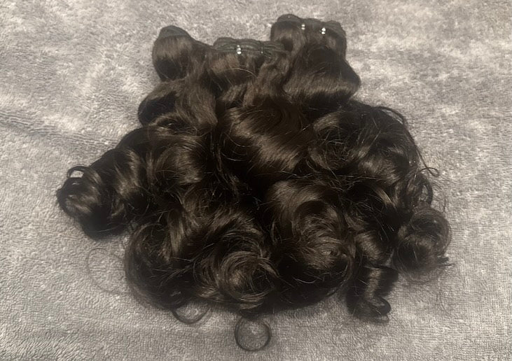 Bundles of human hair natural natural loose curl plied together