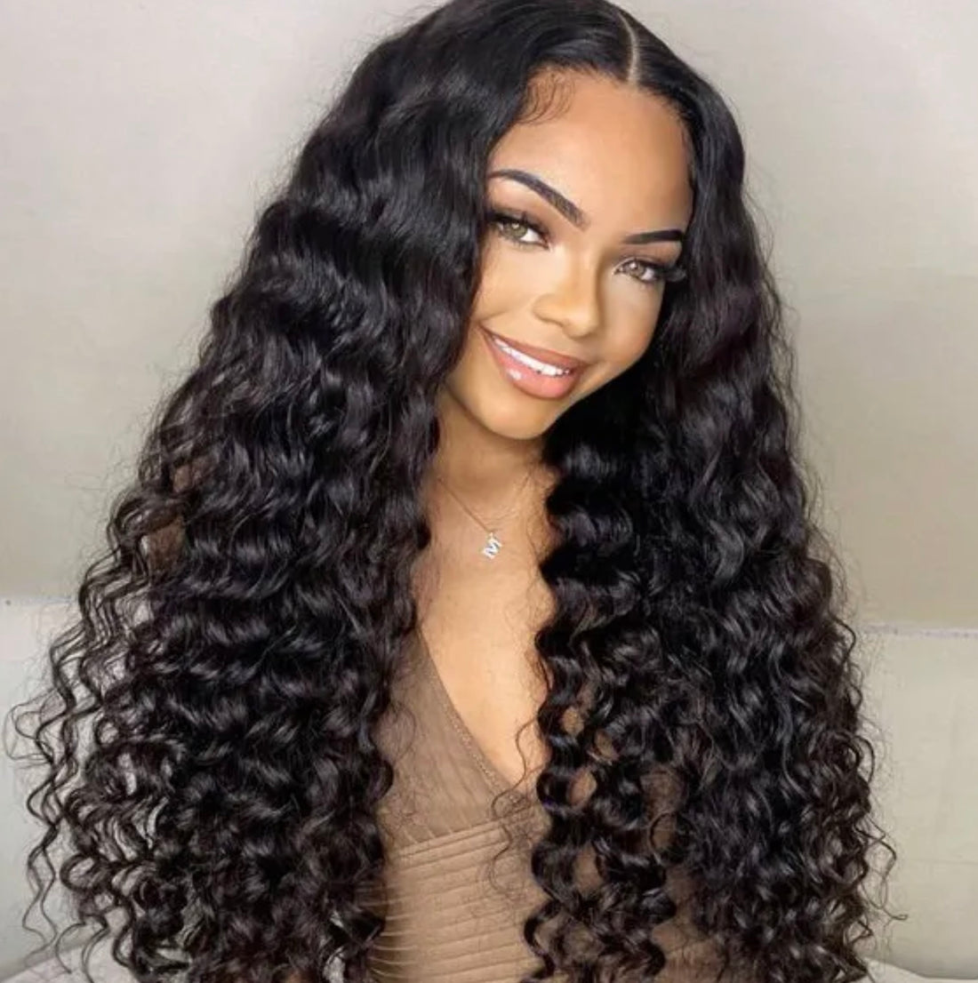 Smiling beautiful afro Caribbean woman wearing Brazilian natural human hair deep loose wave