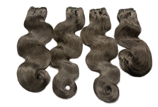 Four bundles of dark brown human brazilian hair extensions on a white background