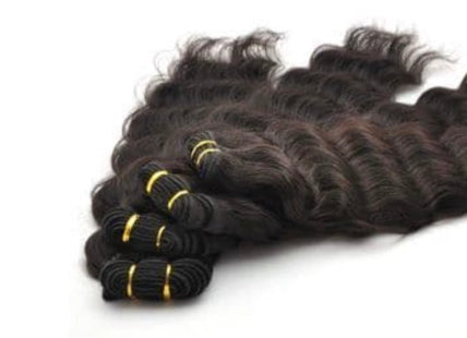 Bundles of wavy Human hair extensions on a white background