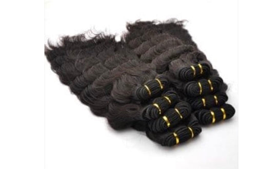 Bundles of Human wavy black hair extensions on a white background