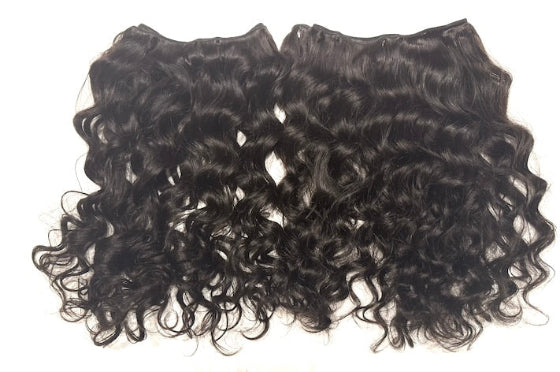 Two pieces of Brazilian loose curly hair extensions on a white background
