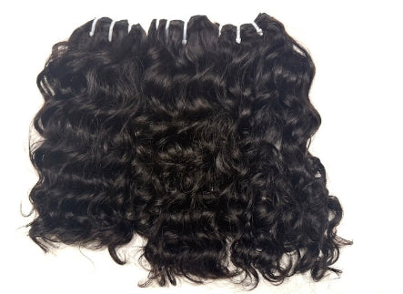 Three bundles of Brazilian Black loose curly human hair extensions on a white background