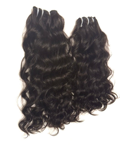 Two bundles of Brazilian loose curl hair extensions on a white background