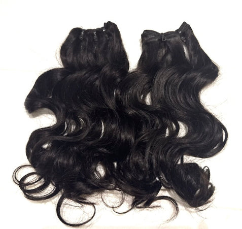 Two Set of black hair natural wave extensions bundles on a white background