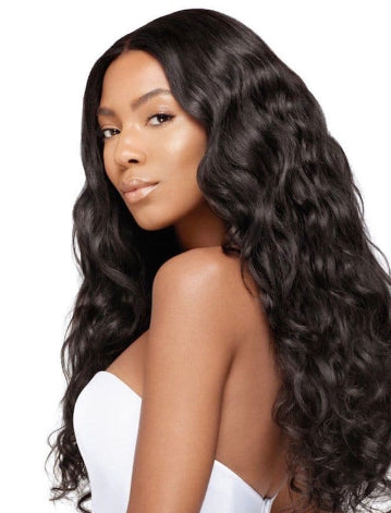 Woman with long, Brazilian natural wavy black hair wearing a white top on a white background