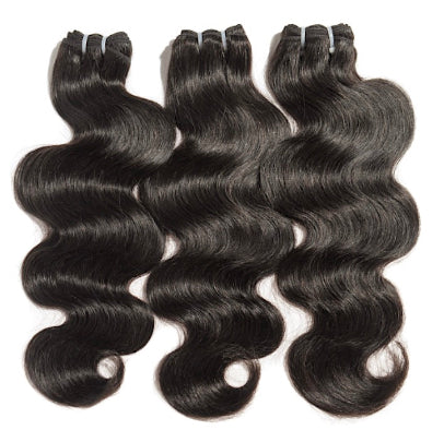Three bundles of black human wavy hair extensions on a white background