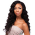 Woman with long, wavy Peruvian black human hair extension wearing a light gray dress with embellishments.