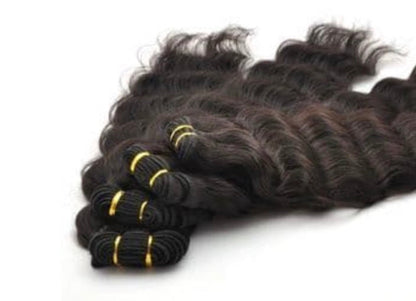 Bundles of wavy Human  hair extensions on a white background
