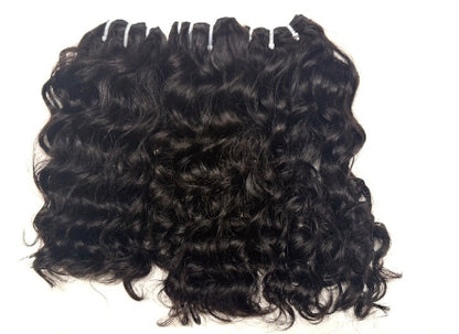 Three bundles of Brazilian Black loose  curly human hair extensions on a white background