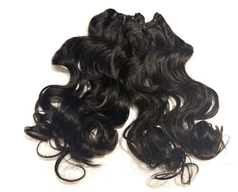 Black Brazilian natural wavy hair extensions on a white background