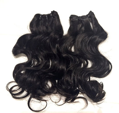 Two Set of black hair natural wave  extensions bundles on a white background